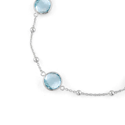 Sterling Silver Bezel Bracelet With Small Silver Stations And Blue Topaz Round Gemstones